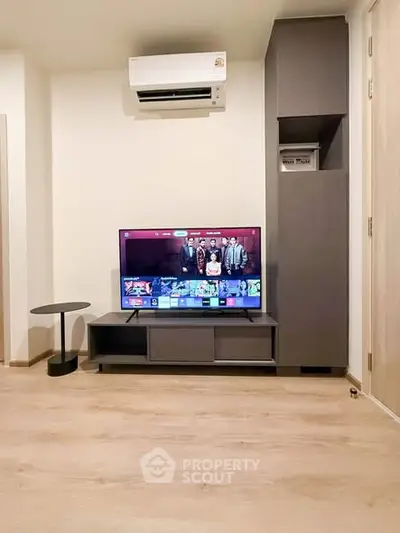 Modern living room with sleek TV setup and stylish air conditioning unit.