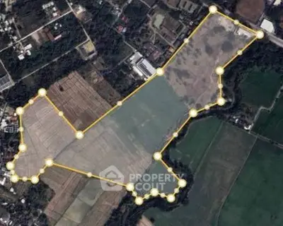 Aerial view of expansive land plot outlined for real estate development.