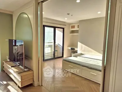 Modern bedroom with sliding doors and natural light in stylish apartment