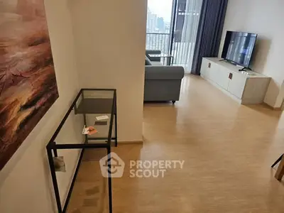 Modern living room with sleek furniture and city view balcony