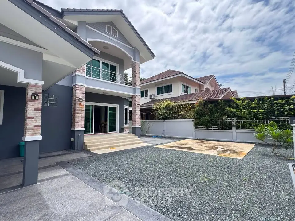 Stunning two-story house with modern architecture and spacious driveway in a serene neighborhood.
