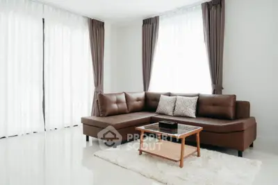 Modern living room with brown leather sectional sofa and elegant curtains