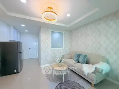 Modern living room with elegant chandelier and cozy sofa in stylish apartment