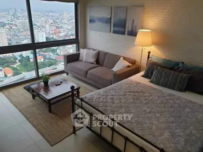 Stunning bedroom with panoramic city view and cozy seating area