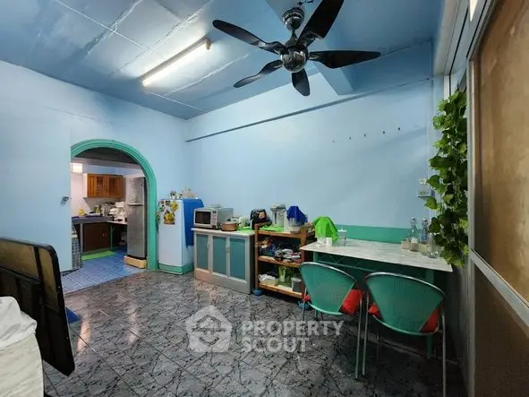 Charming interior with ceiling fan and cozy dining area in a vibrant home setting.