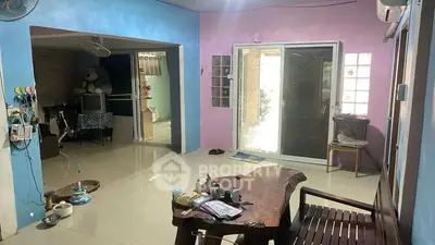 Spacious living room with unique wooden furniture and colorful walls