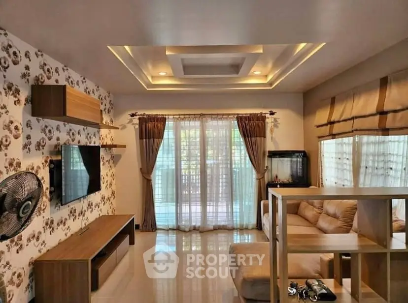 Spacious living room with modern decor and large windows for natural light.