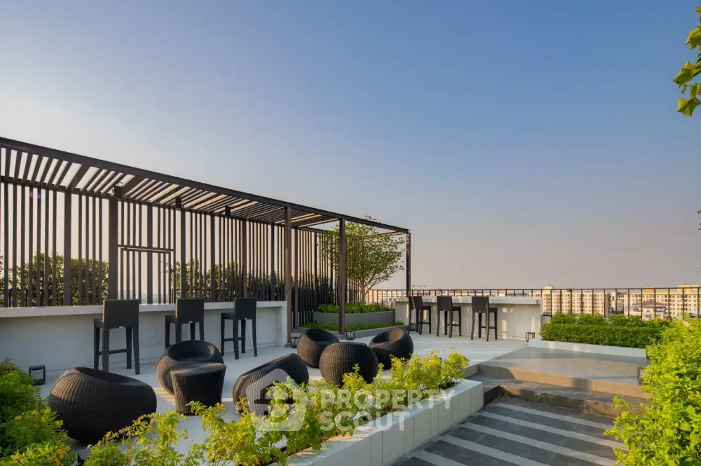 Stunning rooftop terrace with modern seating and panoramic city views