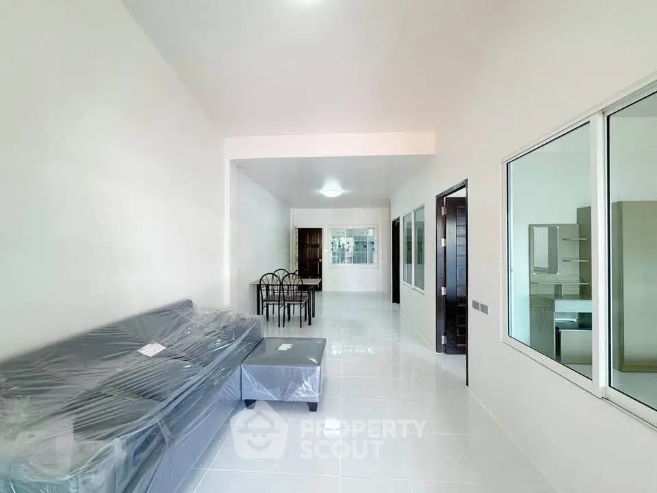 Spacious modern living room with sleek furniture and open layout, perfect for family gatherings.