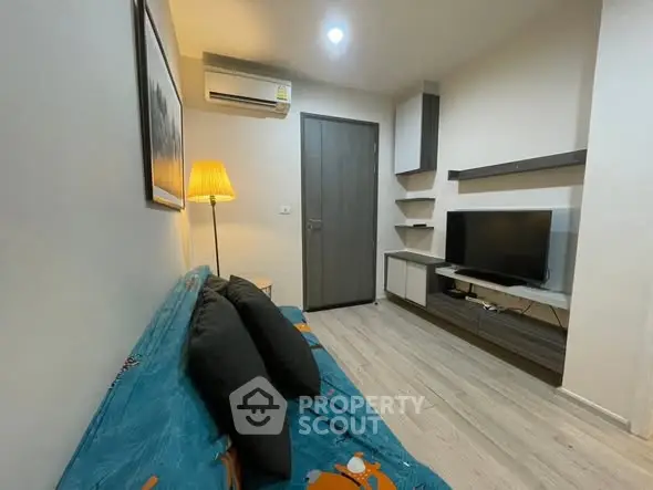 Cozy living room with modern decor and wall-mounted TV, perfect for relaxation.