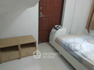 Cozy bedroom with wooden door and modern furniture, perfect for a comfortable living space.