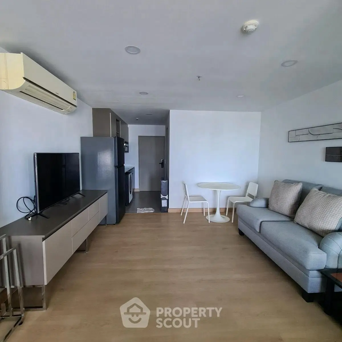 Modern living room with sleek furniture and open kitchen layout