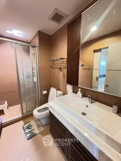 Modern bathroom with sleek fixtures and spacious shower area