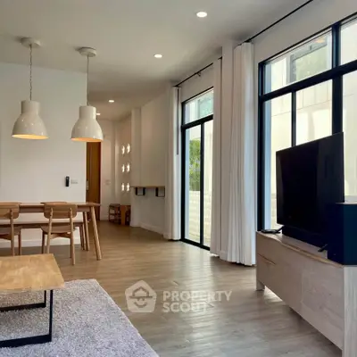 Spacious modern living room with large windows and stylish decor