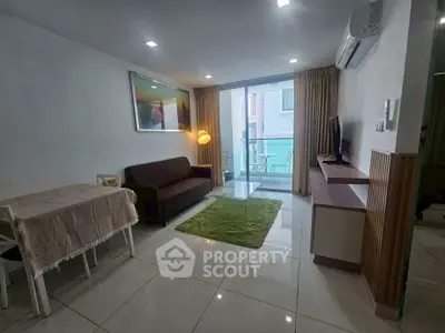 Modern living room with sleek furniture and balcony access