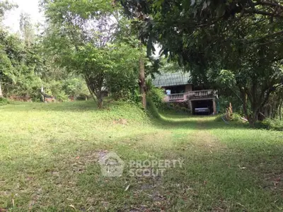 Charming countryside home with lush greenery and spacious lawn, perfect for nature lovers seeking tranquility.