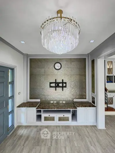 Elegant living room with chandelier and modern wall design