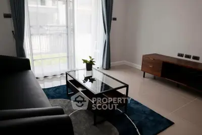 Modern living room with sleek furniture and large window for natural light.