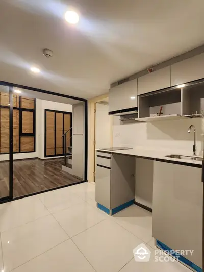 Modern kitchen with sleek cabinetry and open layout in stylish apartment