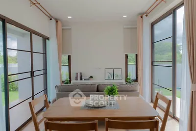 Bright dining area with large windows and garden view in modern home