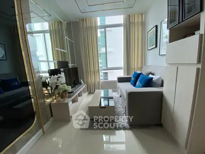 Modern living room with sleek furniture and large windows in a stylish apartment.