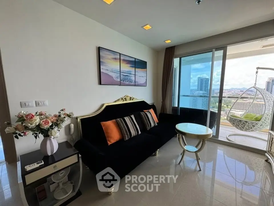 Luxurious living room with elegant decor and stunning city view from the balcony.