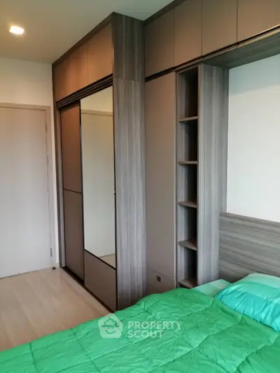 Modern bedroom with sleek built-in wardrobe and cozy green bedding