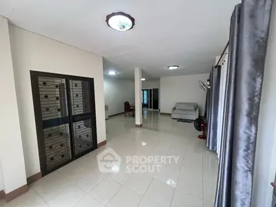 Spacious living room with tiled flooring and modern decor