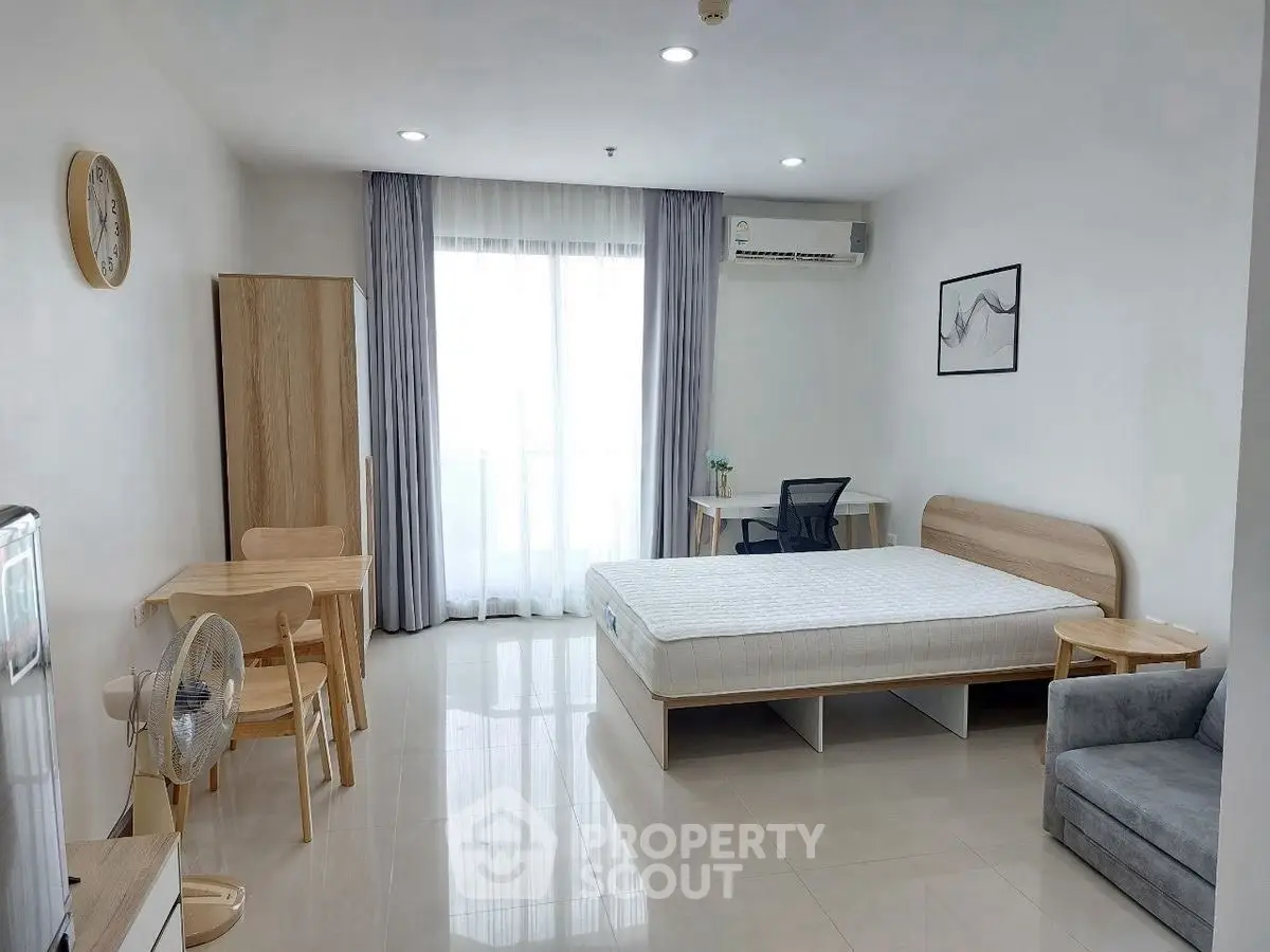 Spacious modern studio apartment with minimalist decor and natural light