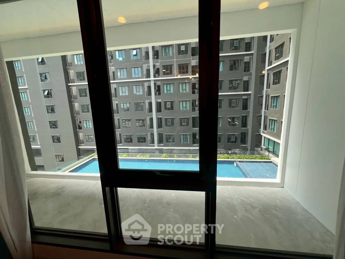 Modern apartment view with pool and building exterior, showcasing urban living.