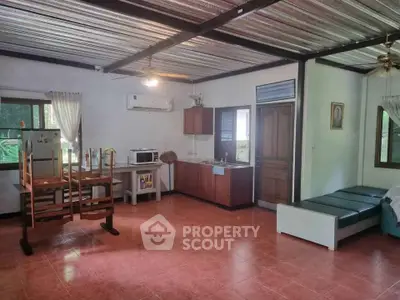 Spacious open-plan living area with kitchen and natural light, perfect for modern living.