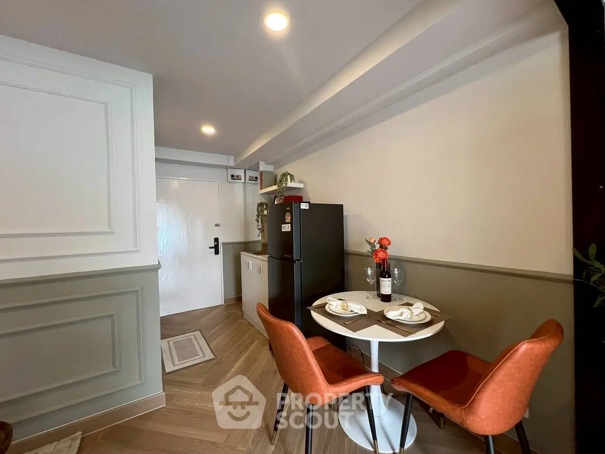 Charming dining nook with modern decor and cozy seating in a stylish apartment.