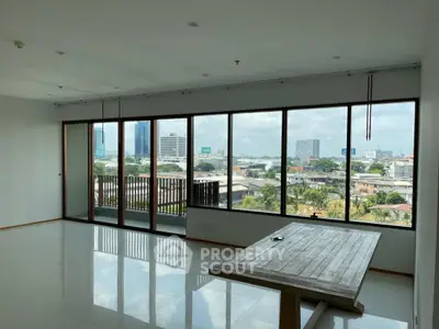Spacious living room with panoramic city view and large windows