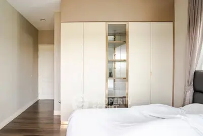 Spacious bedroom with elegant wardrobe and cozy bed in modern apartment