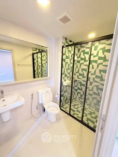 Modern bathroom with geometric tile shower and sleek fixtures