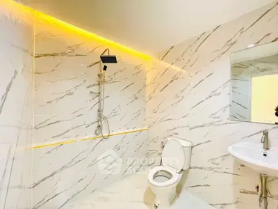 Luxurious modern bathroom with marble tiles and ambient lighting