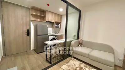 Modern compact kitchen with open layout and cozy living area in stylish apartment