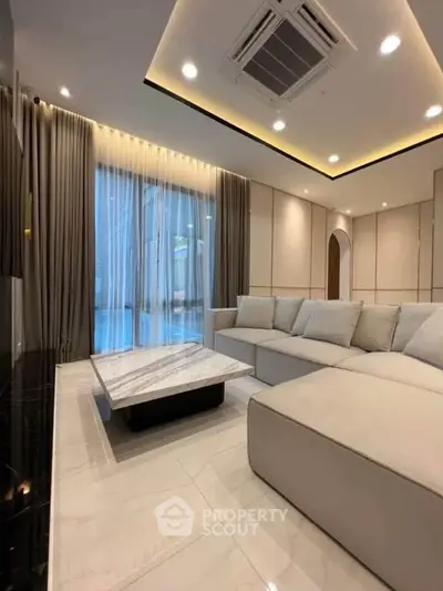 Luxurious modern living room with elegant decor and spacious seating area.