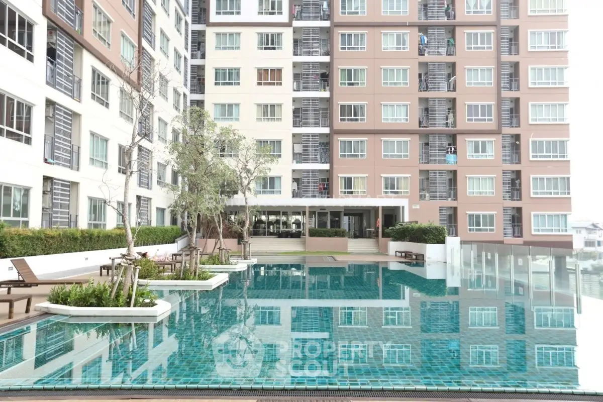 Modern condominium with a luxurious swimming pool and stylish exterior design.