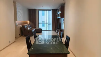 Spacious modern living room with elegant dining area and large window view.