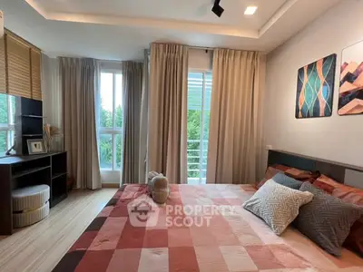 Cozy bedroom with large windows and stylish decor in modern apartment