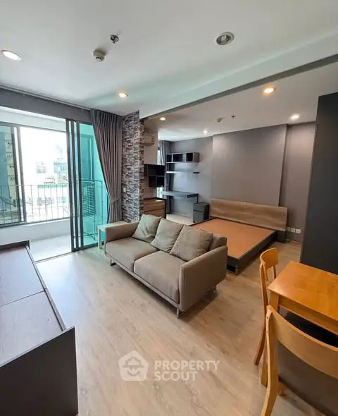 Modern open-plan living room with balcony in urban apartment