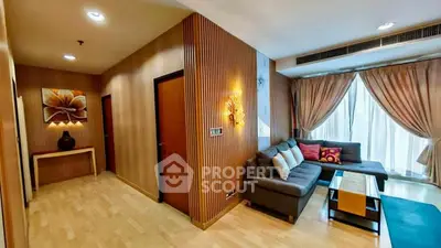 Spacious living room with modern decor and large windows in a stylish apartment.