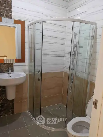 Modern bathroom with glass shower enclosure and sleek design