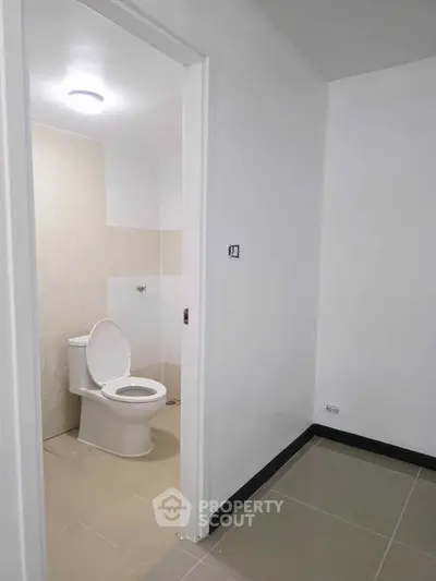 Minimalist bathroom with modern toilet and neutral tile design