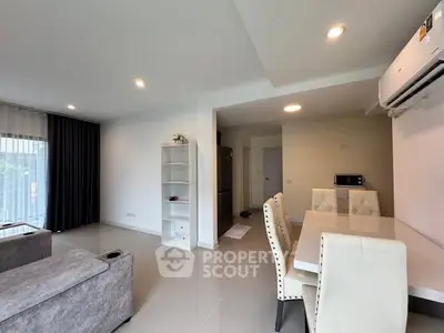 Spacious modern living room with dining area and air conditioning