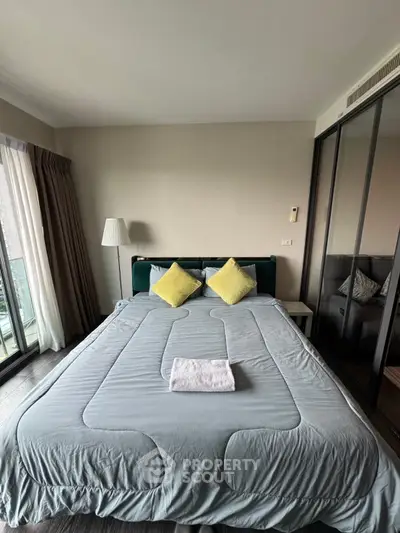 Spacious bedroom with large bed and modern decor in a bright apartment.
