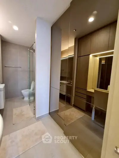 Modern bathroom with glass shower and sleek cabinetry