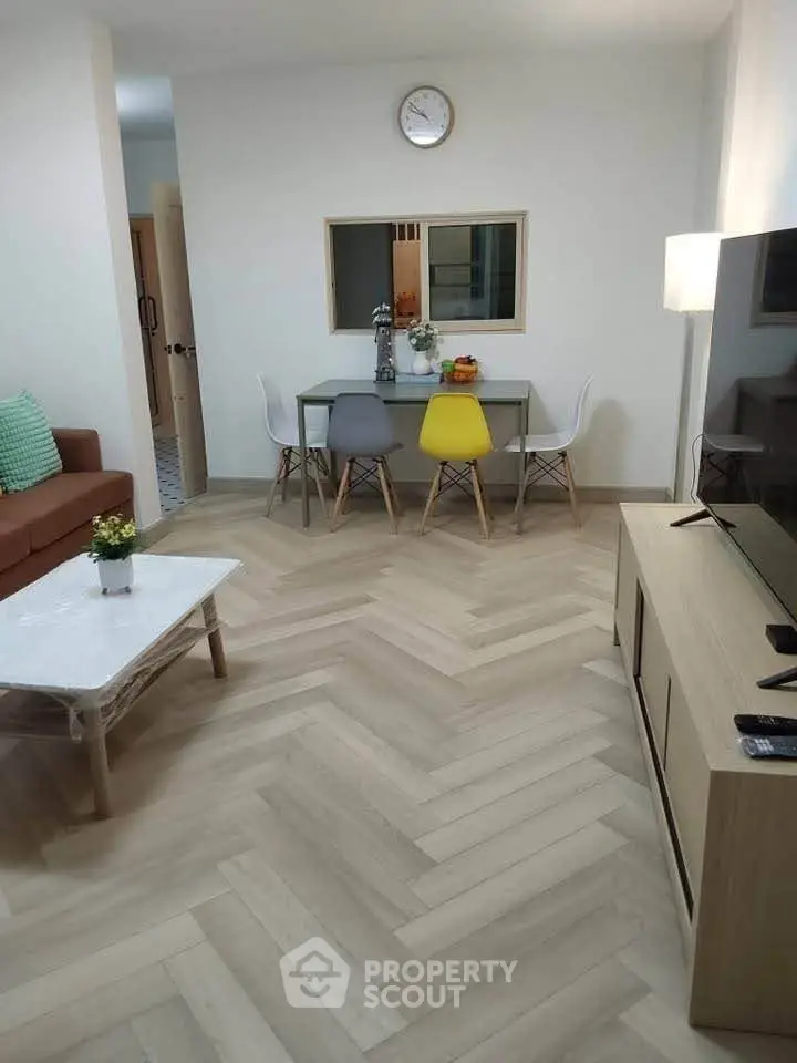 Modern living room with stylish dining area and herringbone flooring