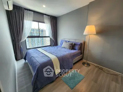 Modern bedroom with large window and stylish decor in high-rise apartment